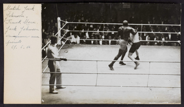 Schwarz-weiß-Foto von zwei Boxern, einem Ringrichter und Zuschauern in einem Boxring, mit "Jack Johnson vs Frank Morgan"-Text in der oberen linken Ecke.