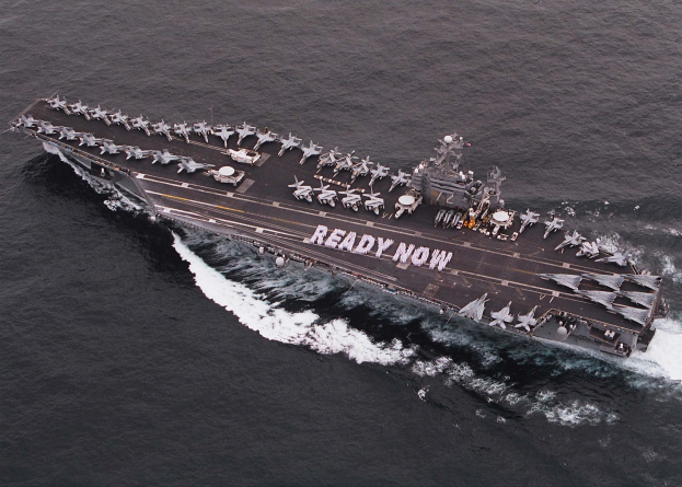 Flugzeugträger USS George H W Bush CVN-68 durchquert den Arabischen Meer mit Flugzeugen und Ausrüstung auf dem Deck, das 'Ready Now' auf der Seite zeigt.